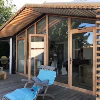 Une pergola en douglas pour protéger le salon du soleil